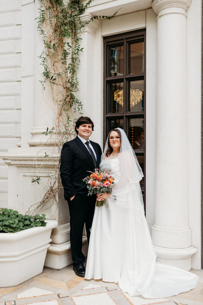 Couple smiling at the camera during their photo shoot