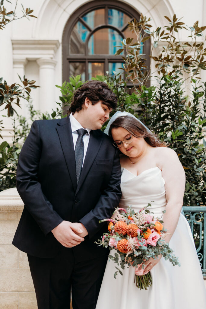 Groom, kissing the bride on the forehead