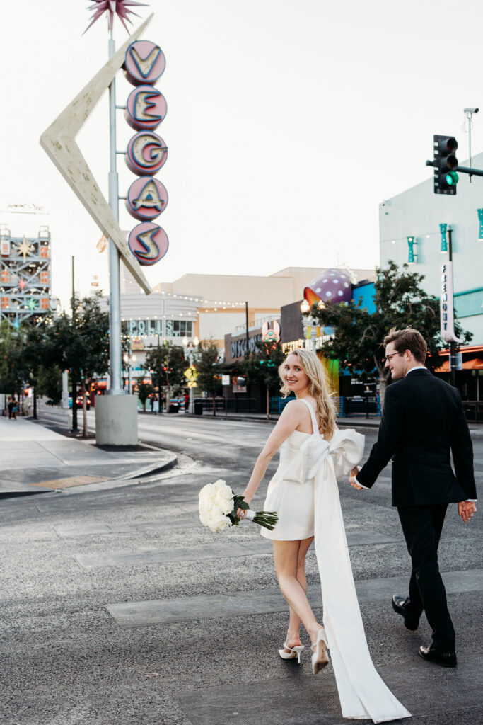 Bride and groom walking around Fremont Street