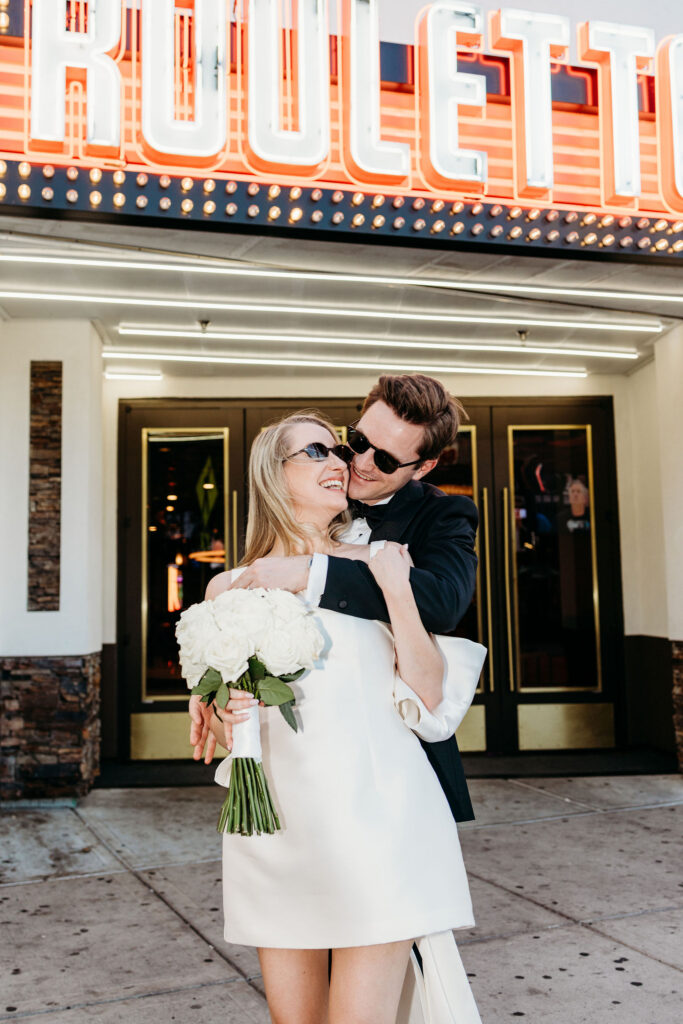 Groom, kissing the bride on the cheek