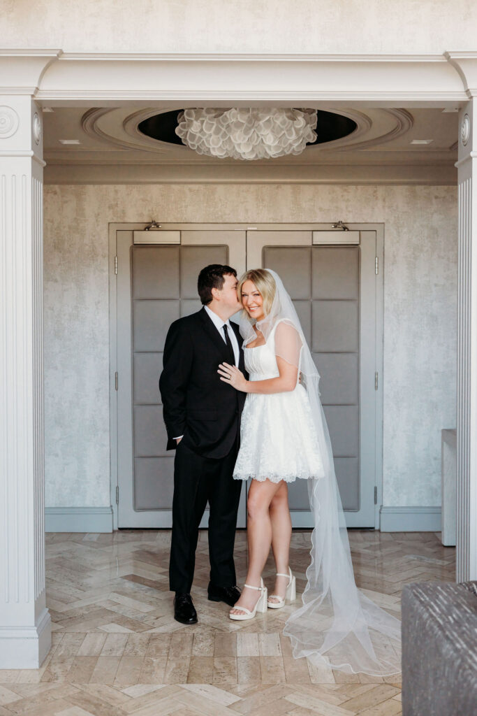 cute picture of the groom kissing the bride on the cheek