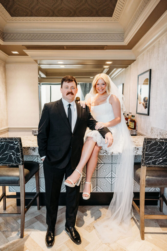 bride and groom smiling at the camera during their bridal portraits