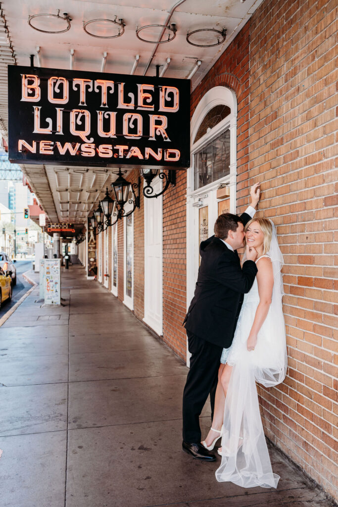 cute picture of the bride and groom in downtown fremont street