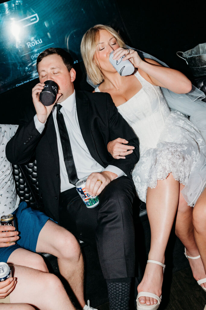 cute picture of the bride and groom heading to their ceremony in a party bus with their guests