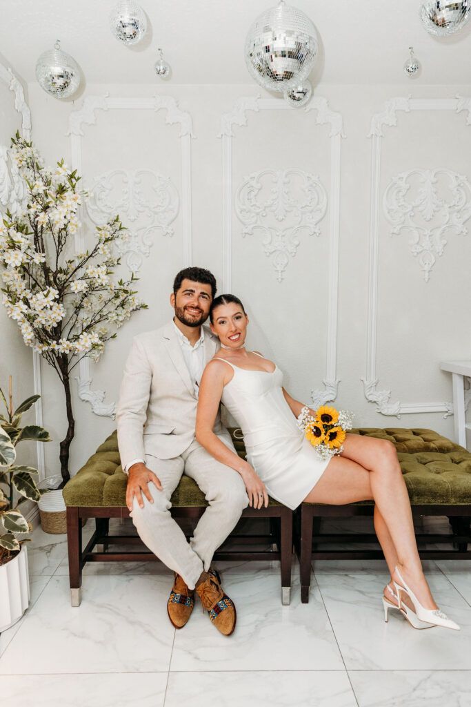 bride and groom smiling at the camera during their photoshoot