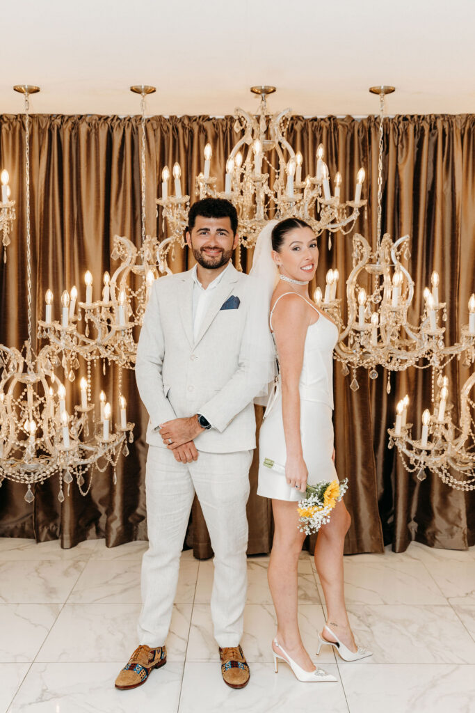 newlyweds smiling at the camera during their photoshoot