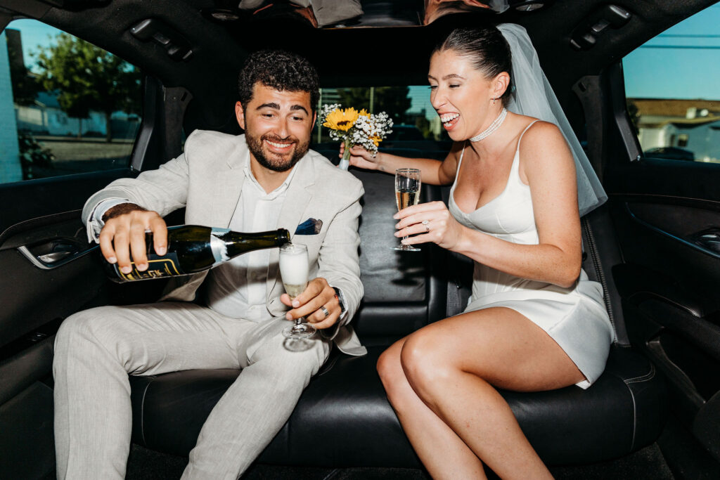 newlyweds celebrating their elopement with champagne