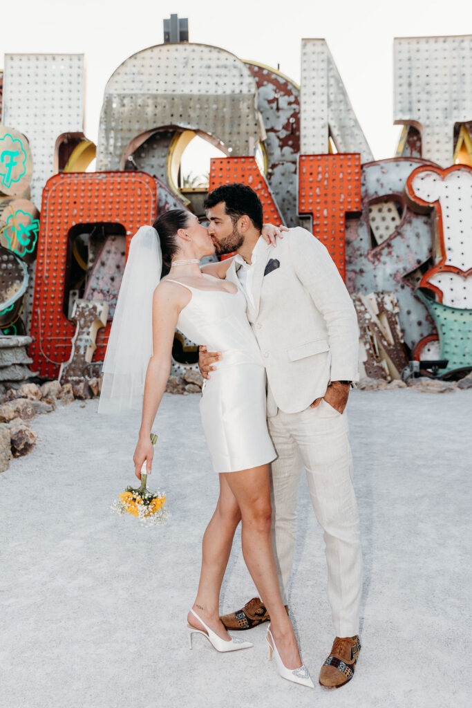 newlyweds smiling at the camera during their photoshoot