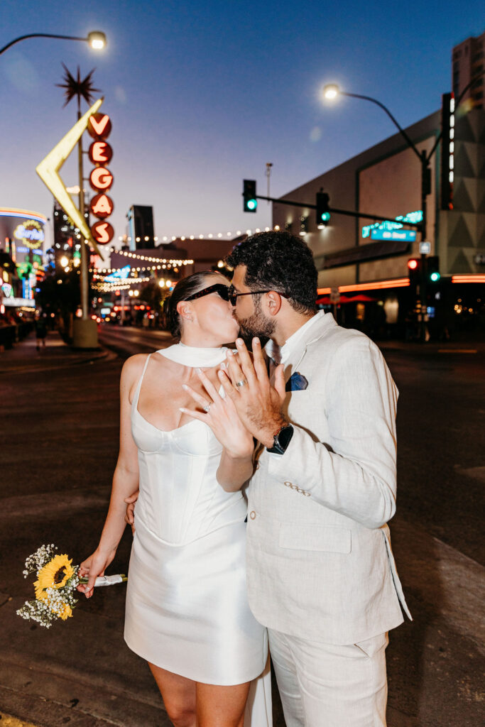 portrait of the newlyweds showing their wedding rings